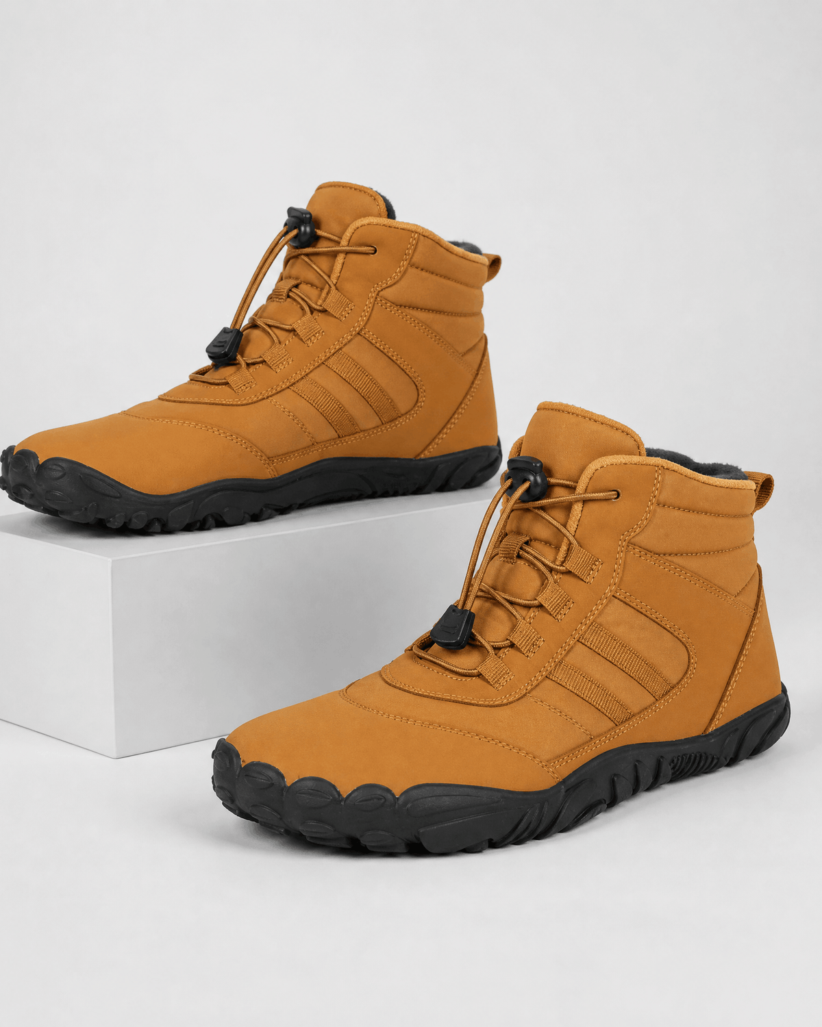 Brown water-repellent winter ankle boots with flexible black rubber soles, fleece-lined collars, and bungee lace toggles.