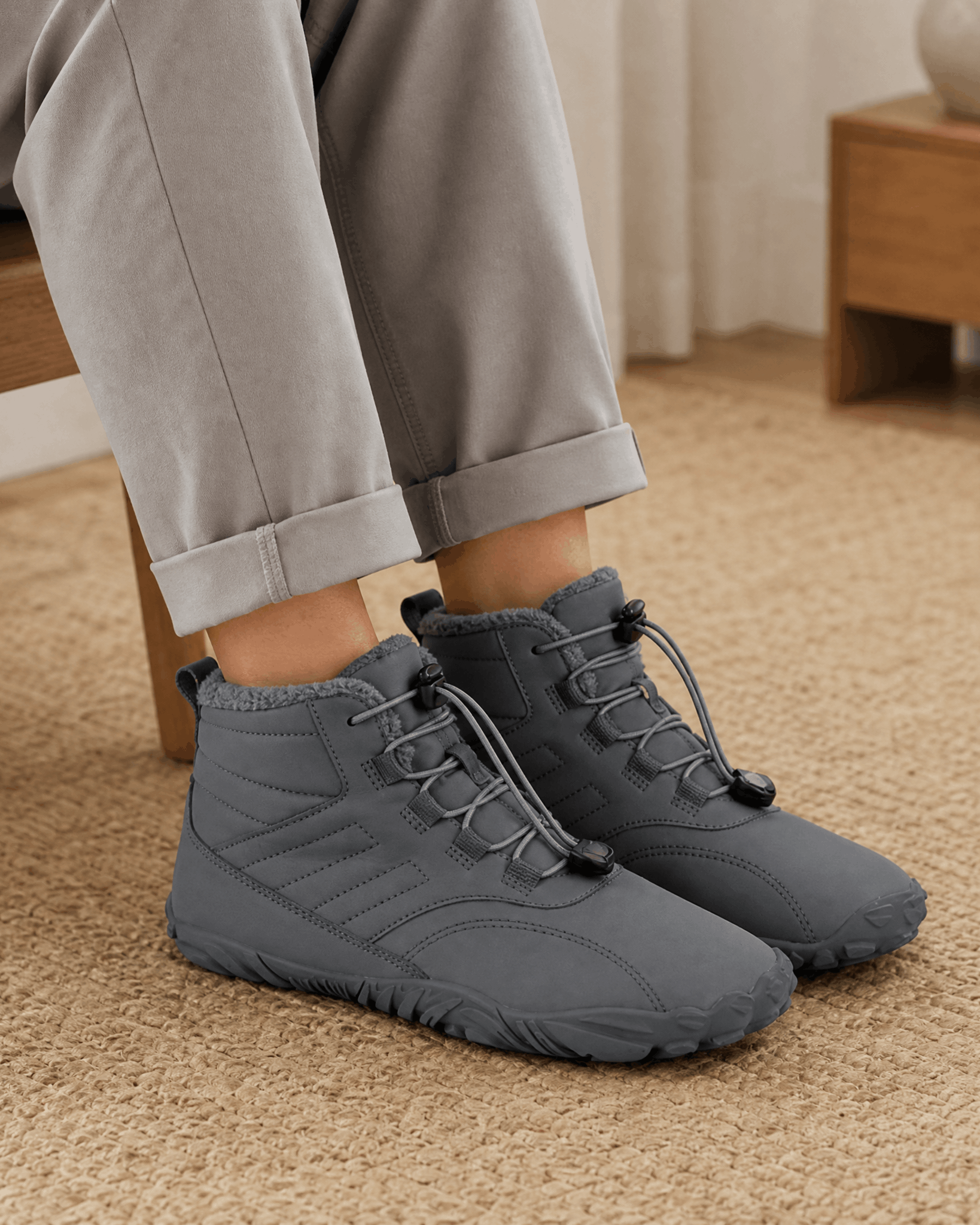 Gray water-repellent winter ankle boots with fleece-lined collars, flexible rubber soles, and bungee lace toggles.