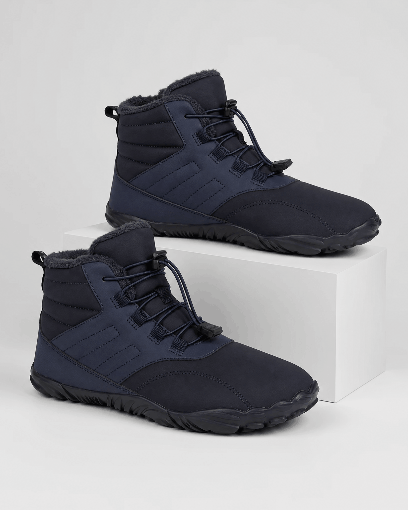 Black water-repellent winter ankle boots with fleece-lined collars, flexible rubber soles, and bungee lace toggles.