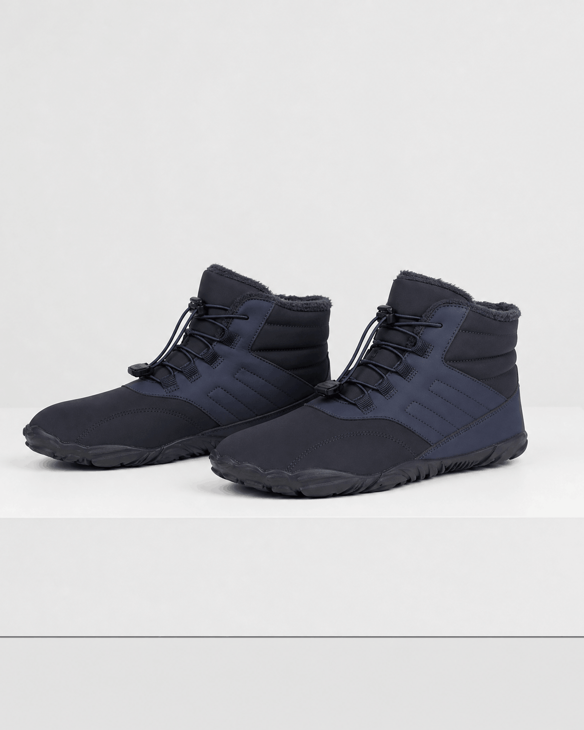 Black water-repellent winter ankle boots with a fleece-lined collar, bungee lace toggle, and flexible rubber sole.