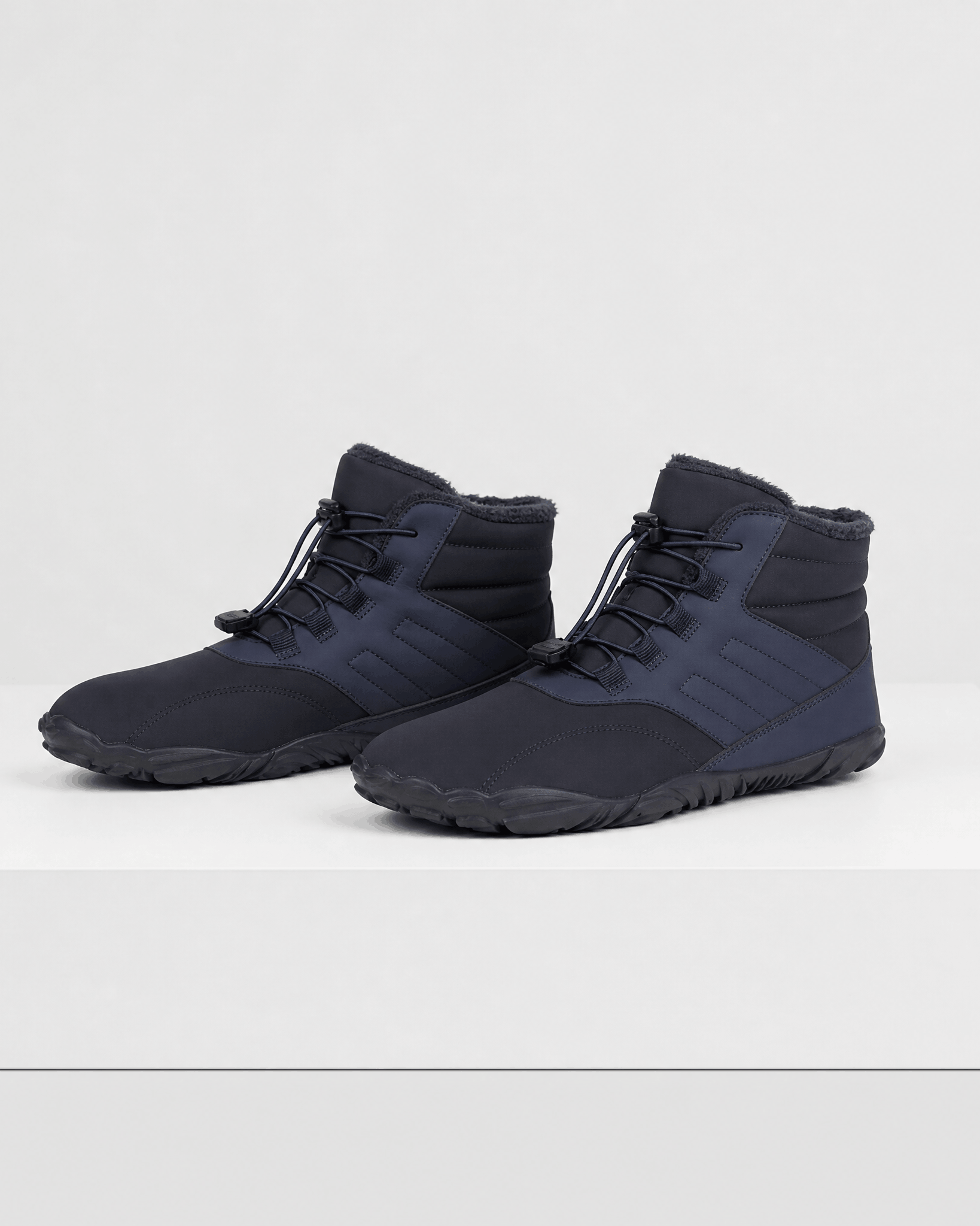 Black water-repellent winter ankle boots with a fleece-lined collar, bungee lace toggle, and flexible rubber sole.