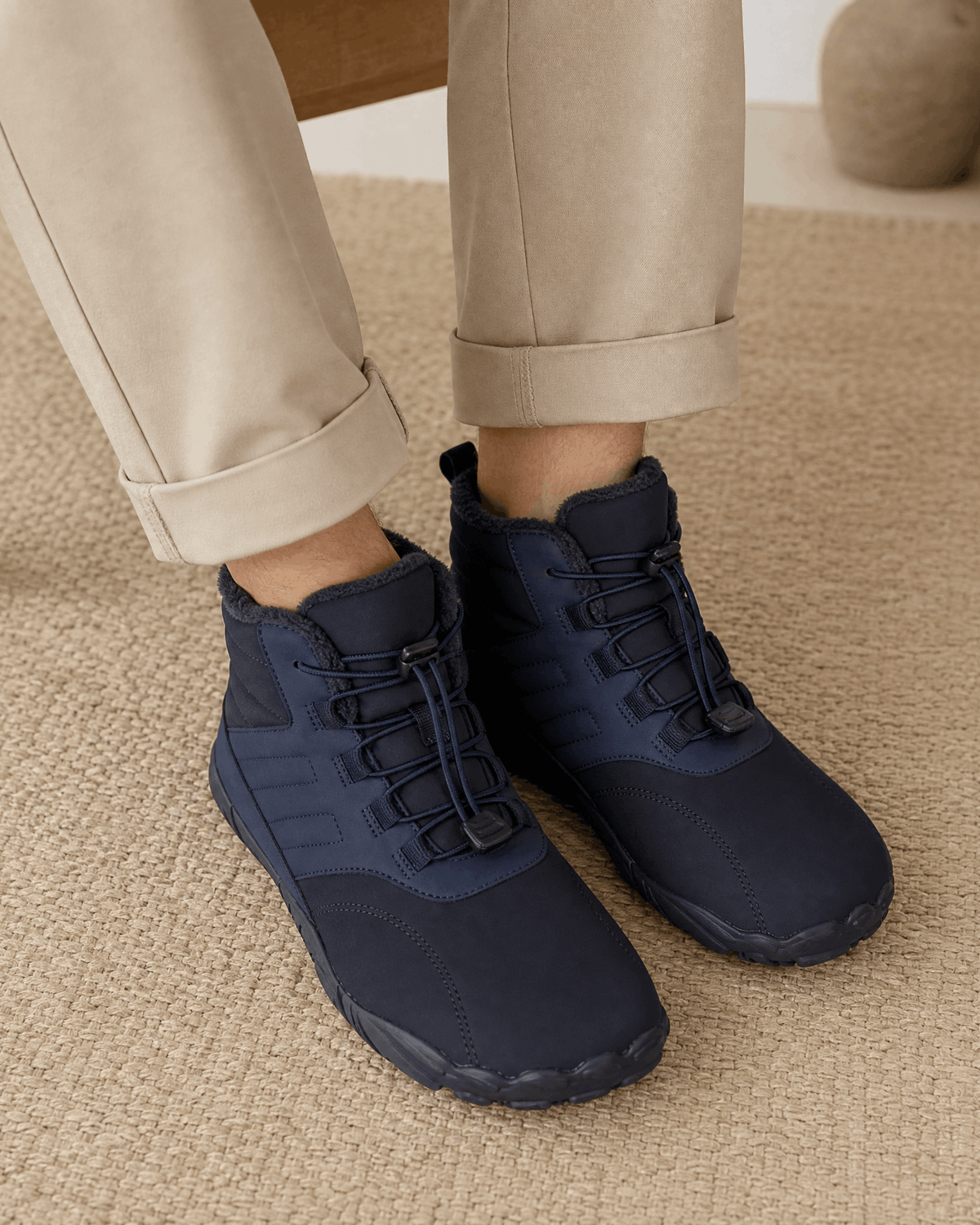 Blue water-repellent winter ankle boots with a fleece-lined collar, bungee lace toggle, and flexible rubber sole.
