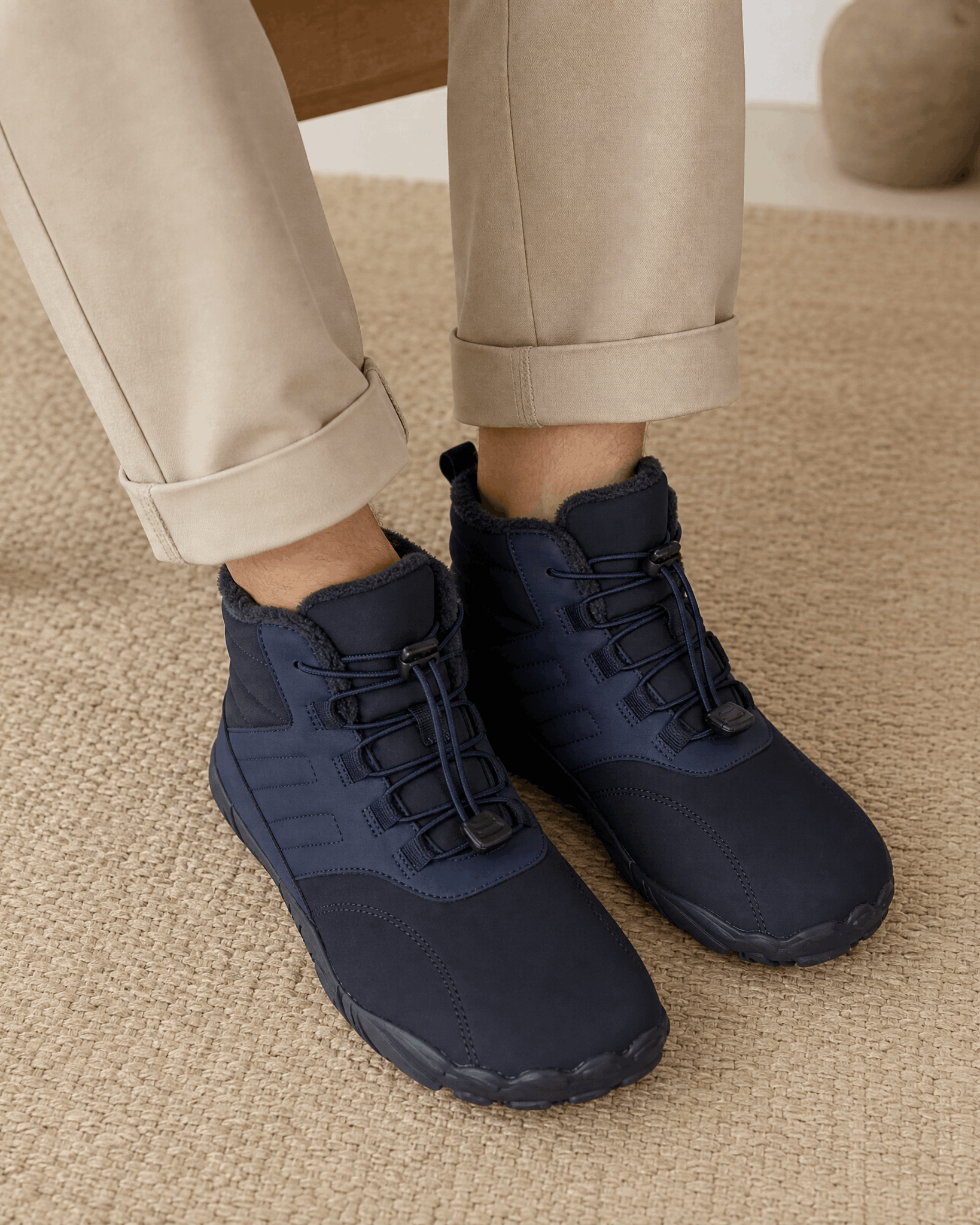 Blue water-repellent winter ankle boots with a fleece-lined collar, bungee lace toggle, and flexible rubber sole.