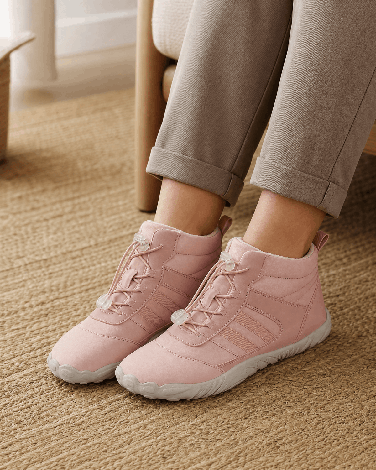 Pink water-repellent winter ankle boots with fleece-lined collars, bungee lace toggles, and flexible rubber soles.