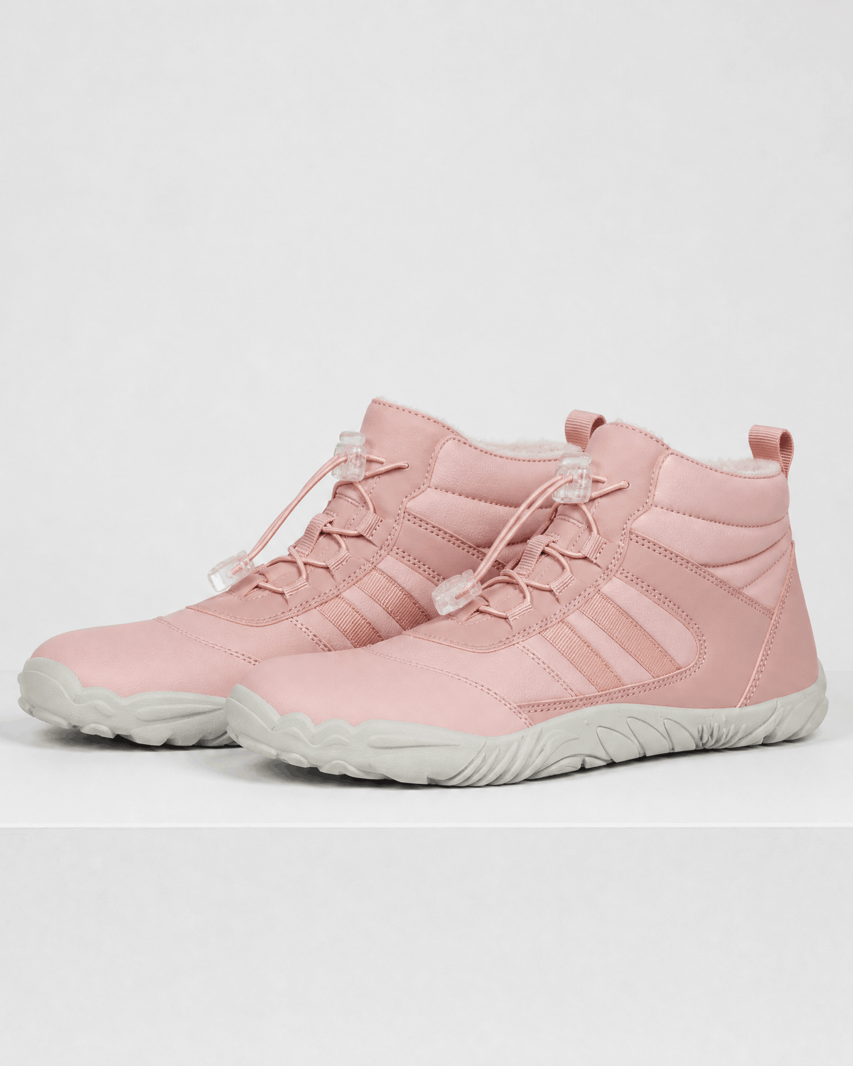 Pink water-repellent winter ankle boots with fleece-lined collars, bungee lace toggles, and flexible rubber soles.