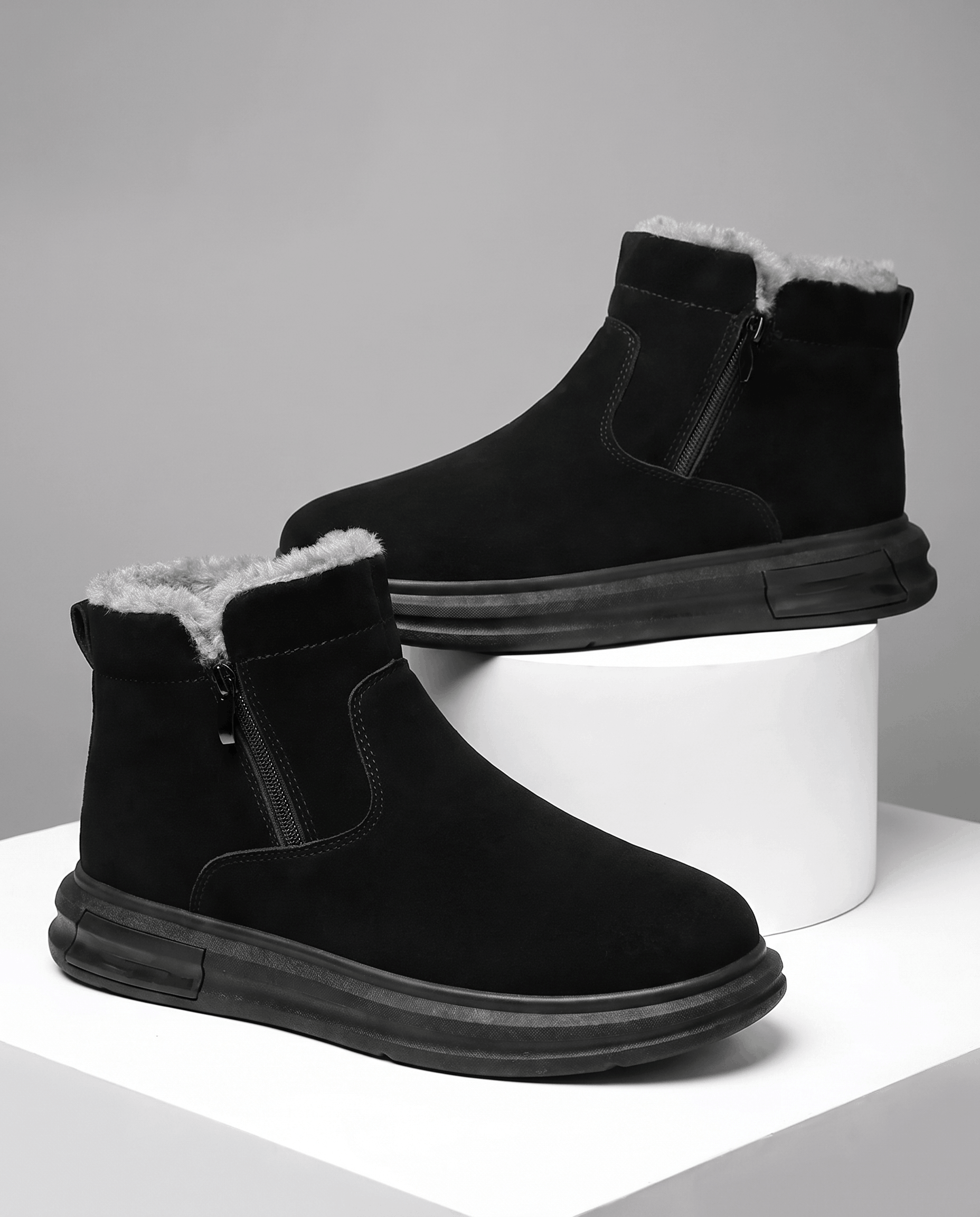 Black wide toe box winter boots for men with side zip and plush fleece lining displayed on white blocks.