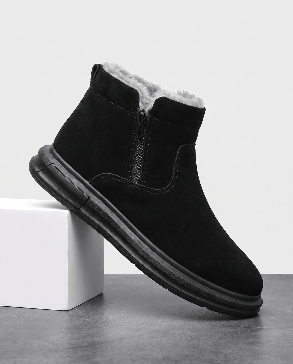 Black fleece-lined winter boot with a wide toe box and side zip shown on a white pedestal.