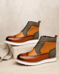 Smooth grain brown wingtip boots with olive matte panels, brogue perforations, and a chunky white cupsole.