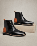Black smooth grain leather ankle boots with wingtip brogue detailing, woven-texture panels, and metal eyelet lacing.