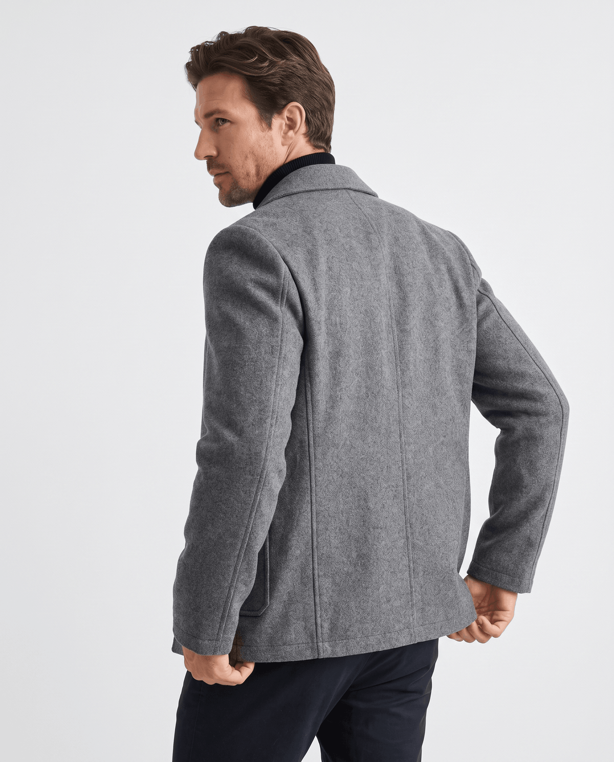Rear three-quarter view of the gray coat showing the sleeve and side seam