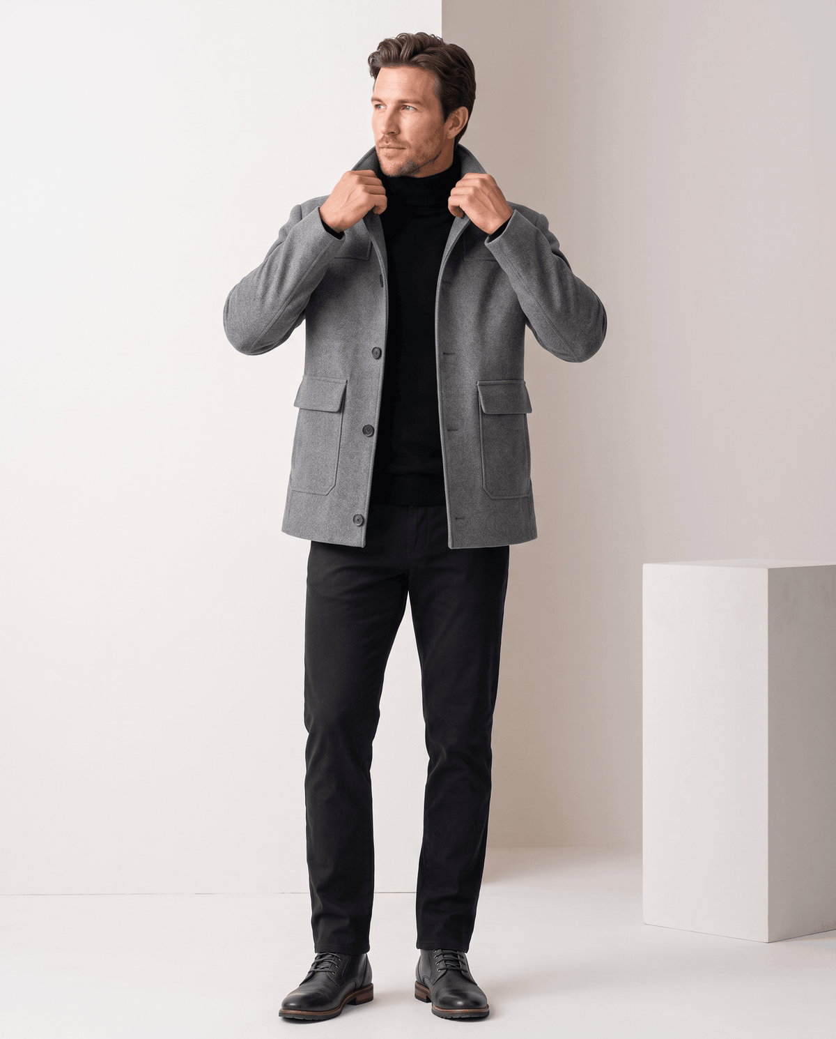 Full-length shot of the gray coat with the collar turned up over dark trousers