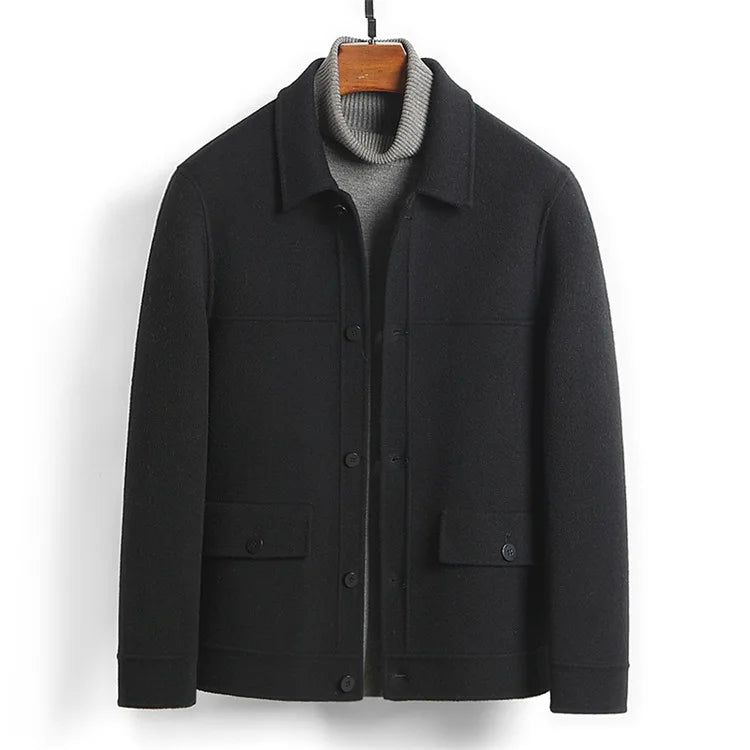 Black jacket on a hanger front view showing the point collar and flap pockets