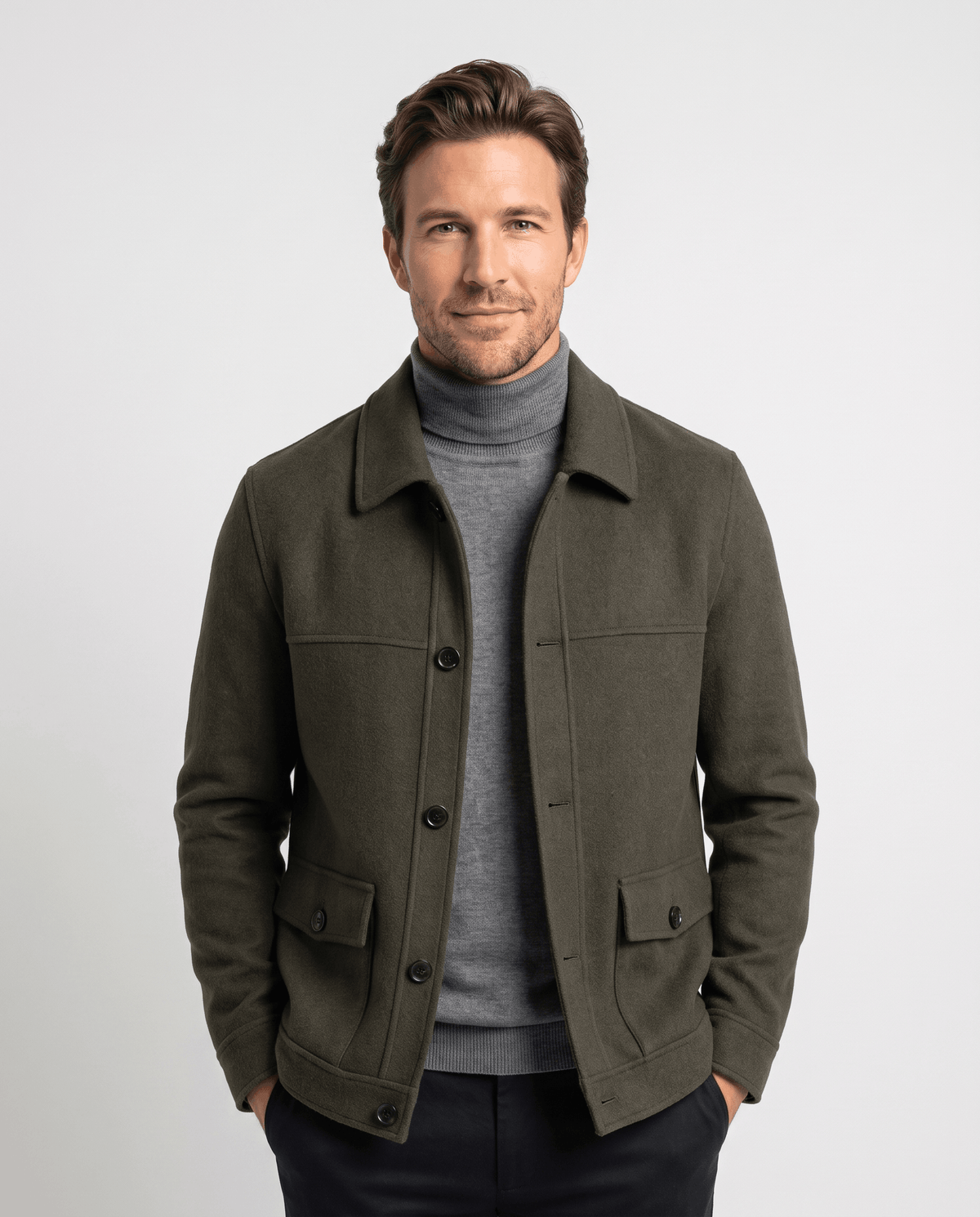 Olive green chore jacket front view buttoned partway over a gray turtleneck