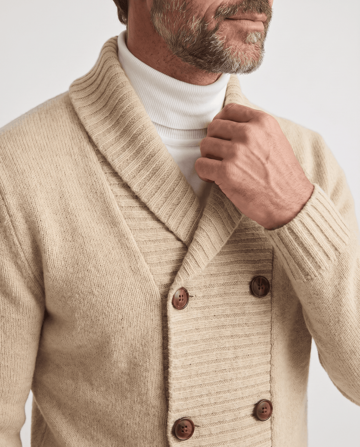 Apricot cardigan shawl collar and brown buttons shown in close view