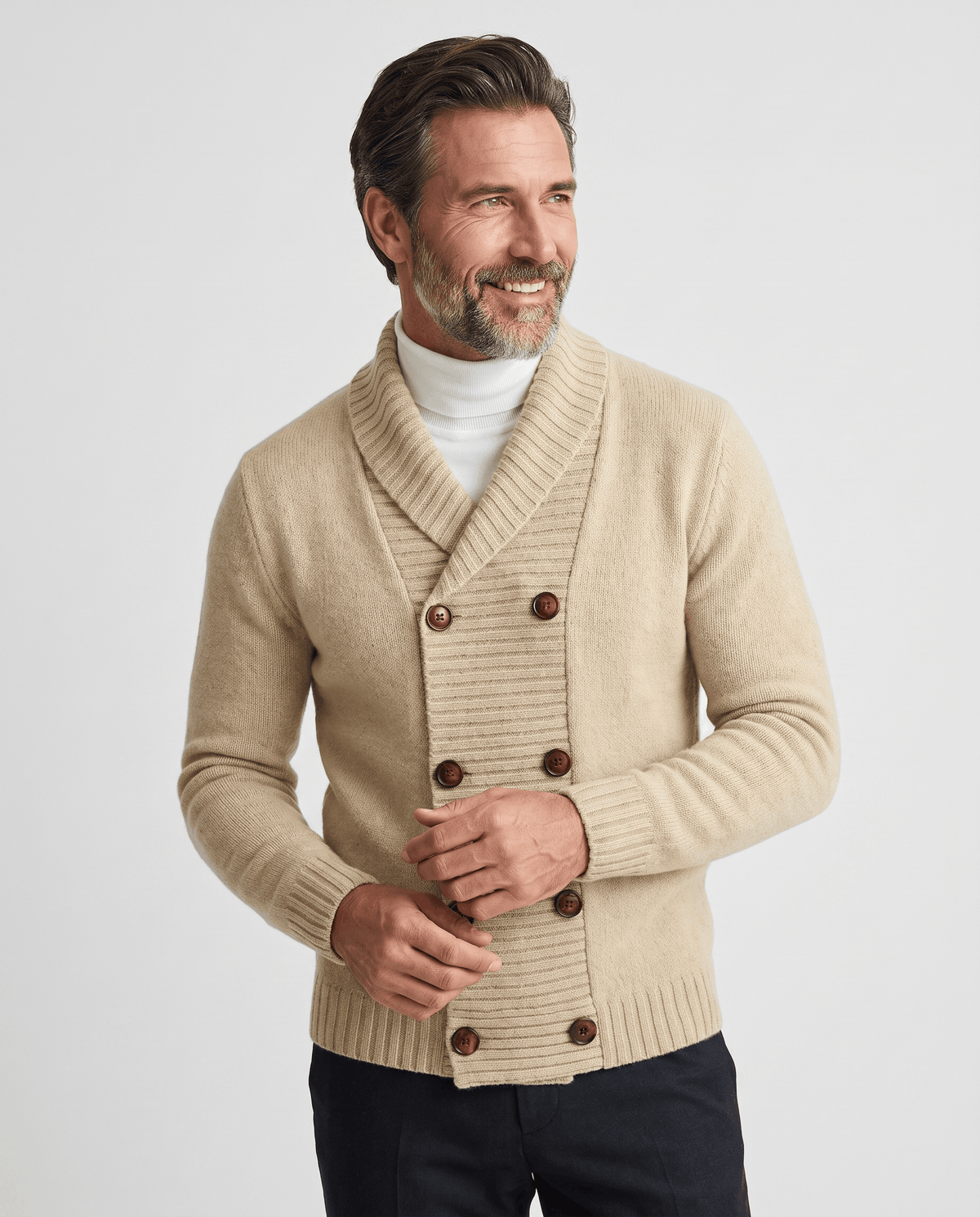 Men's apricot double-breasted shawl collar cardigan worn over a white turtleneck