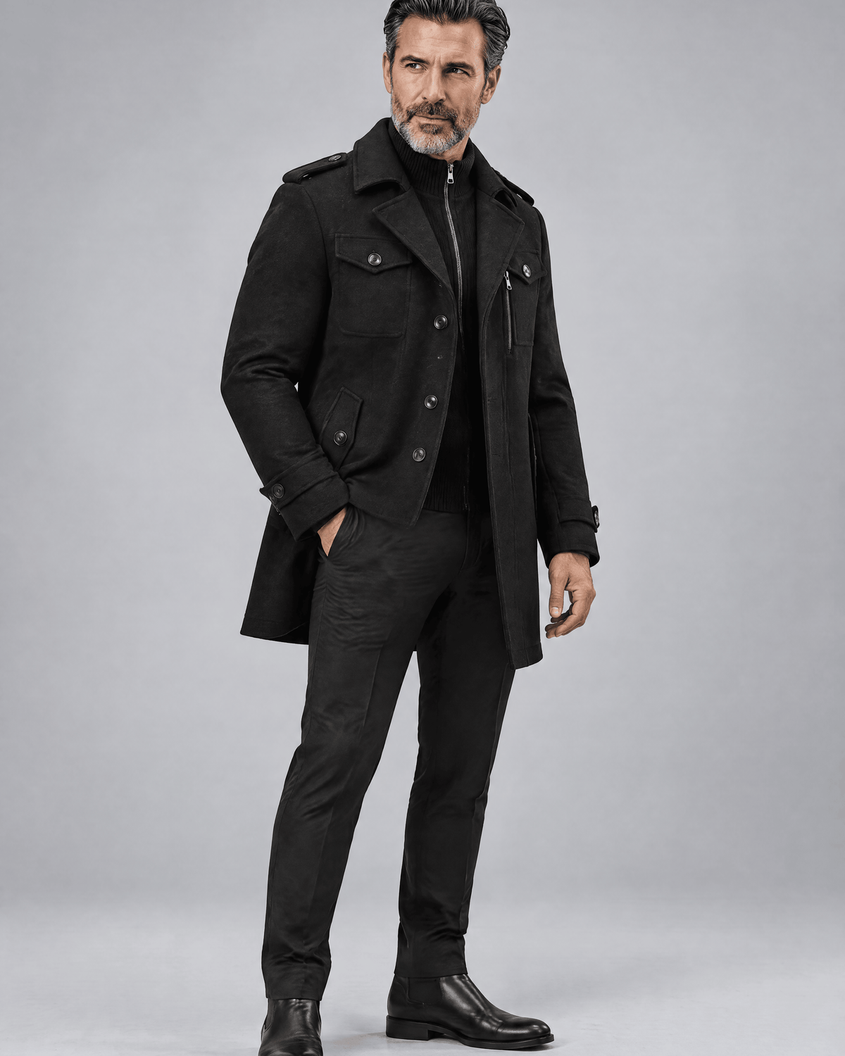 Black thigh-length coat in a three-quarter view with dark trousers and black shoes