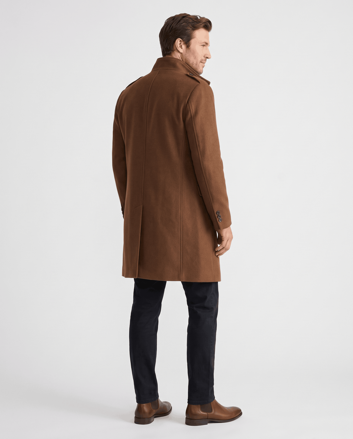 Back view of the brown overcoat worn with dark trousers and brown boots