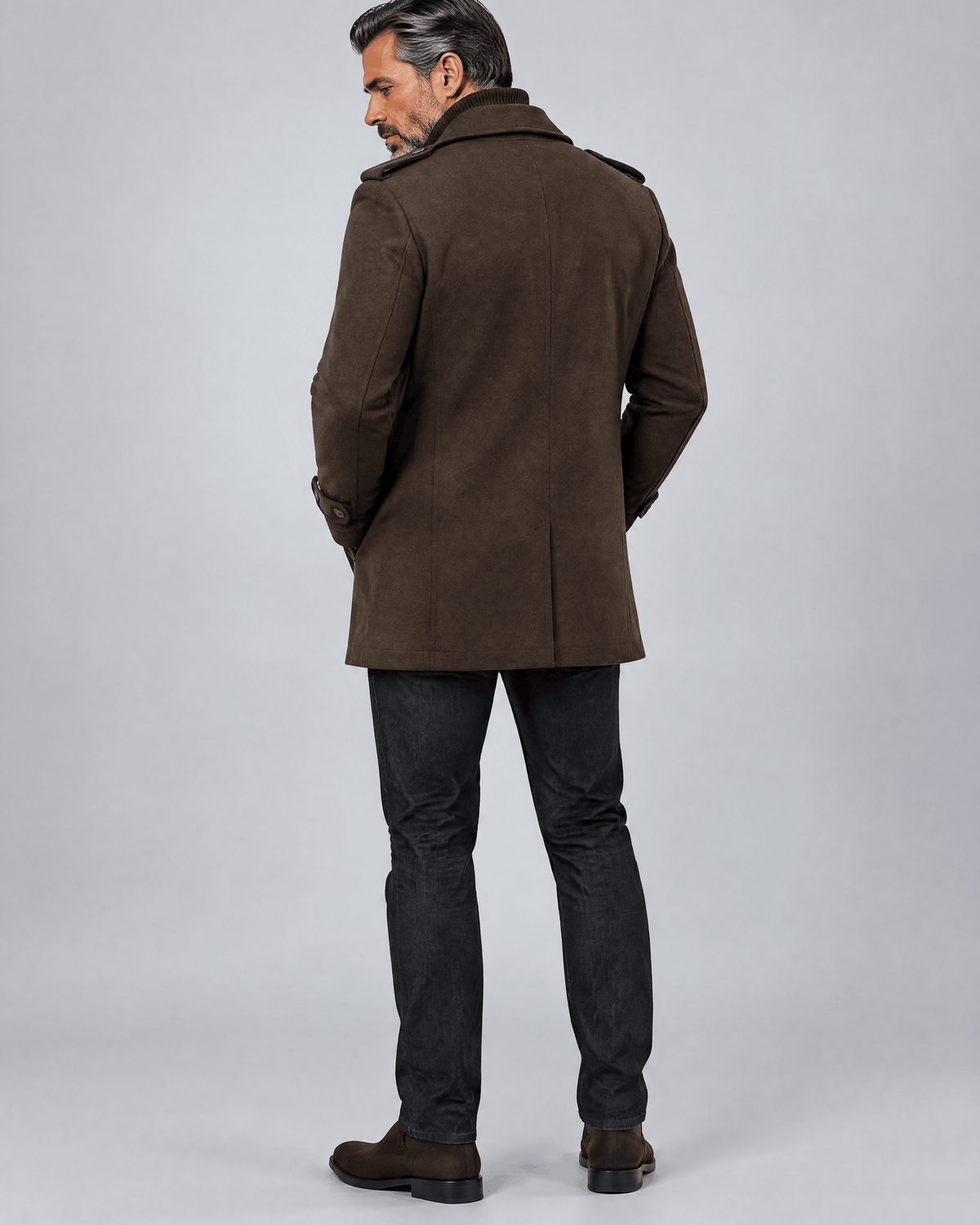Back of the brown coat showing a clean back panel over dark trousers and shoes