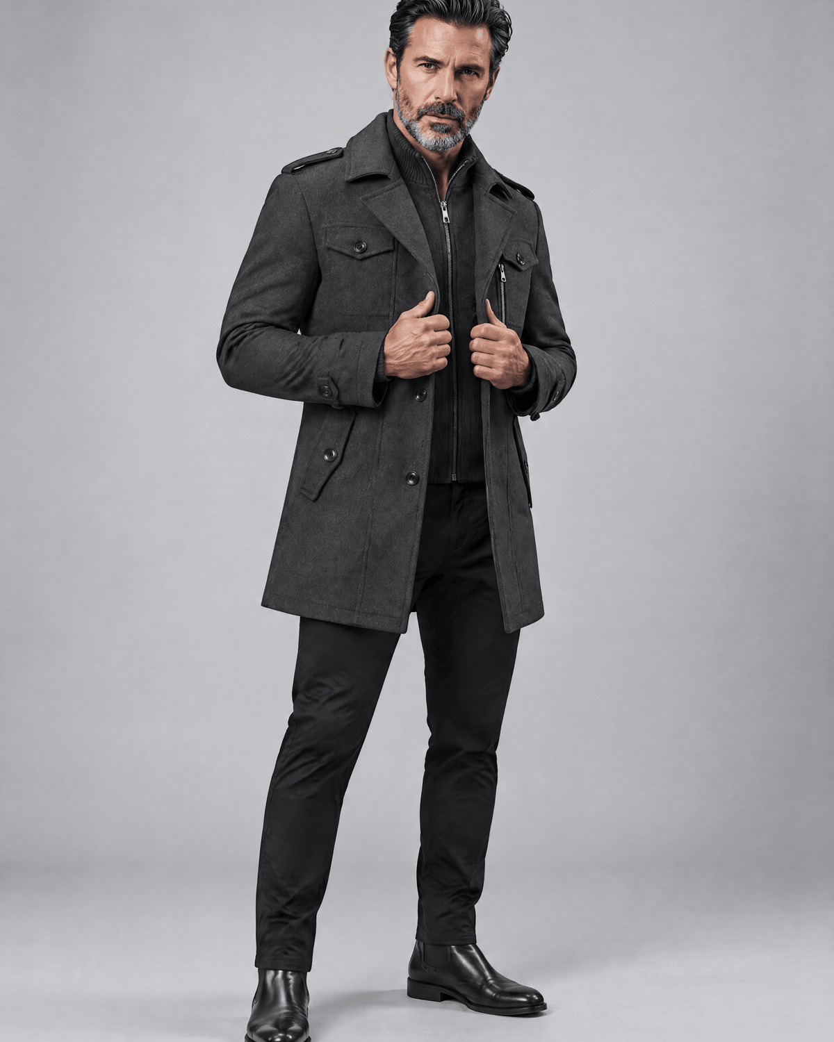 Gray coat in a three-quarter view worn open with dark trousers and black shoes