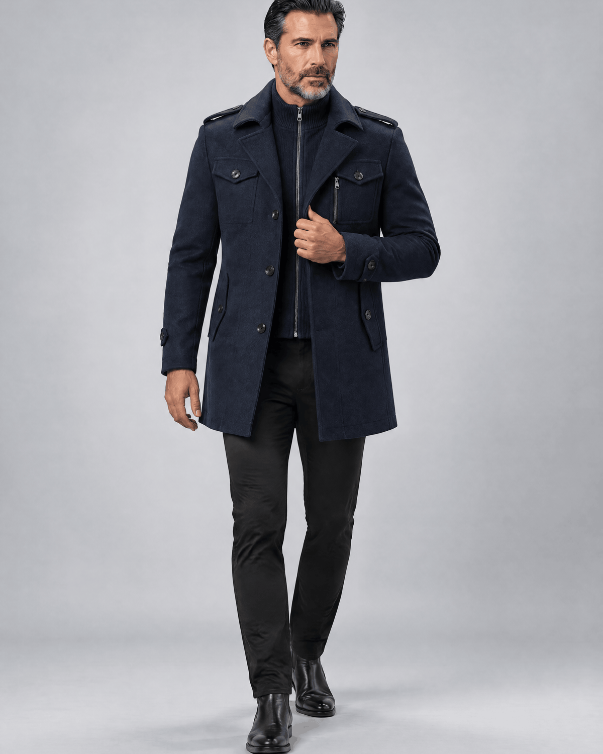 Navy thigh-length coat worn open with dark trousers, front view in studio