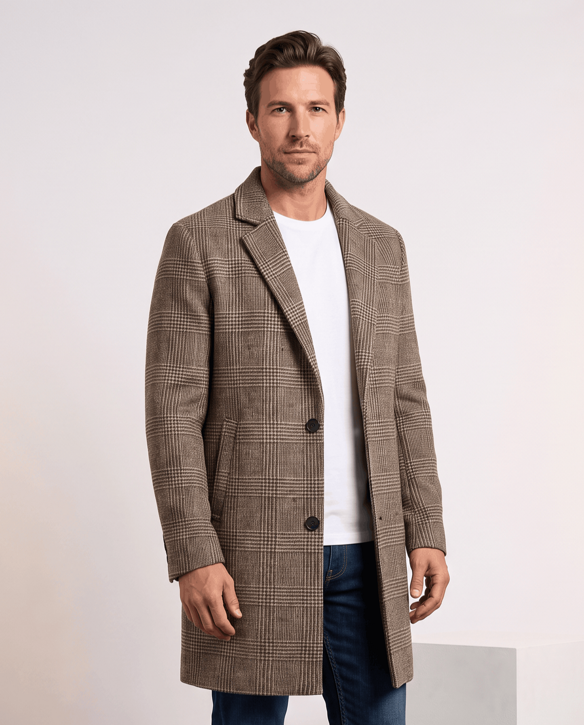 Men's wool blend overcoat in taupe check, worn over a white shirt and jeans