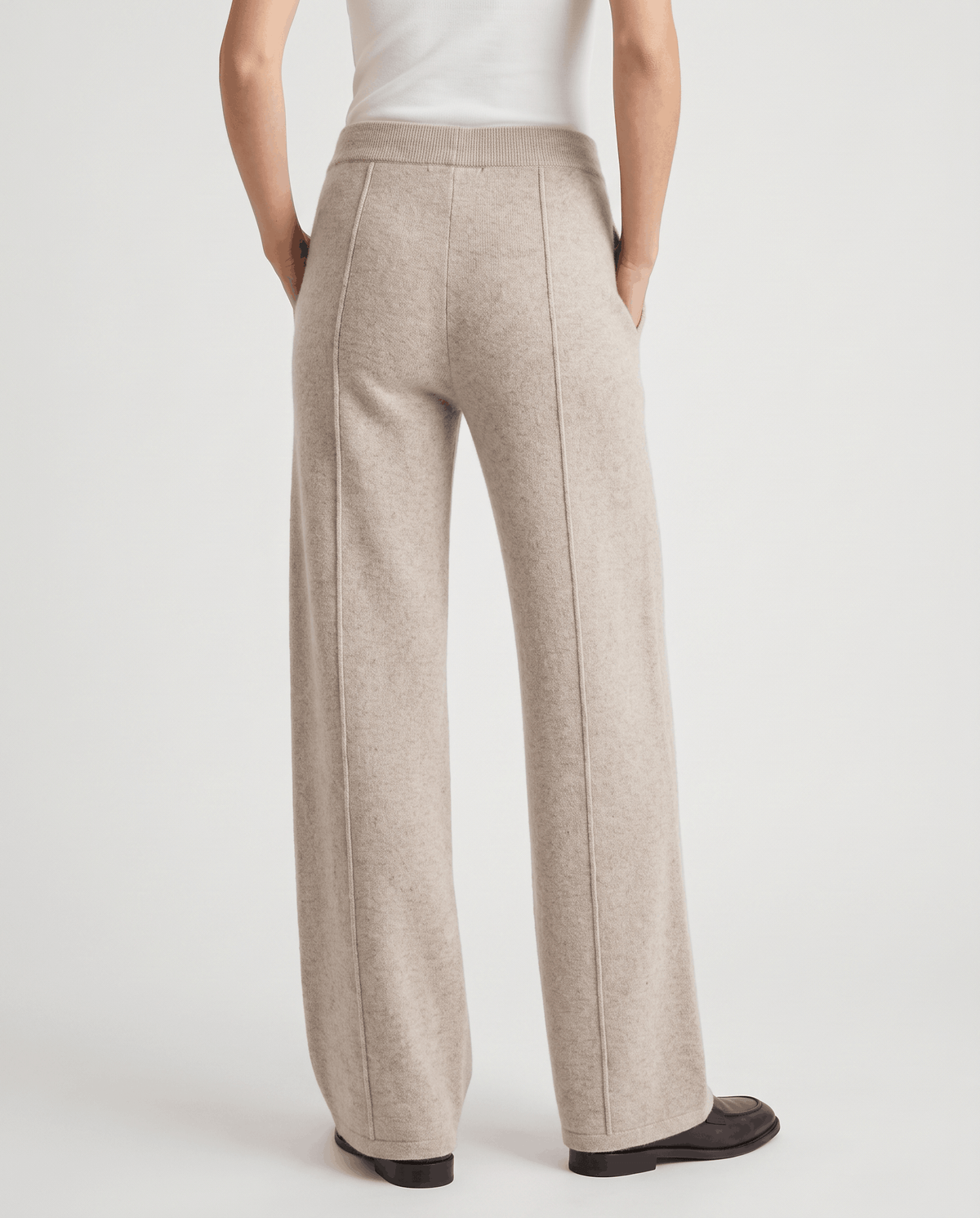 Back view of beige full-length wide-leg pants with center seams