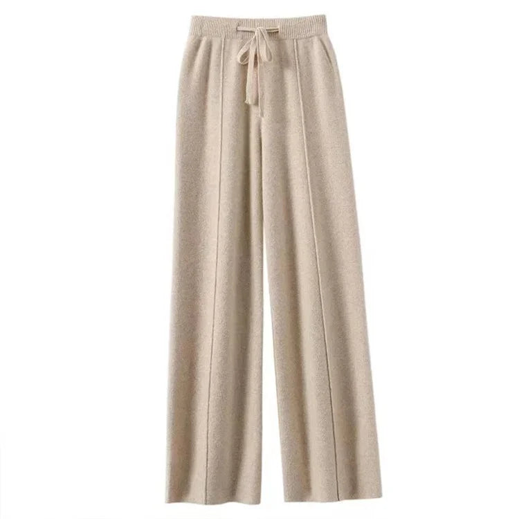 Flat lay of beige wide-leg knit pants with tie waist and seams