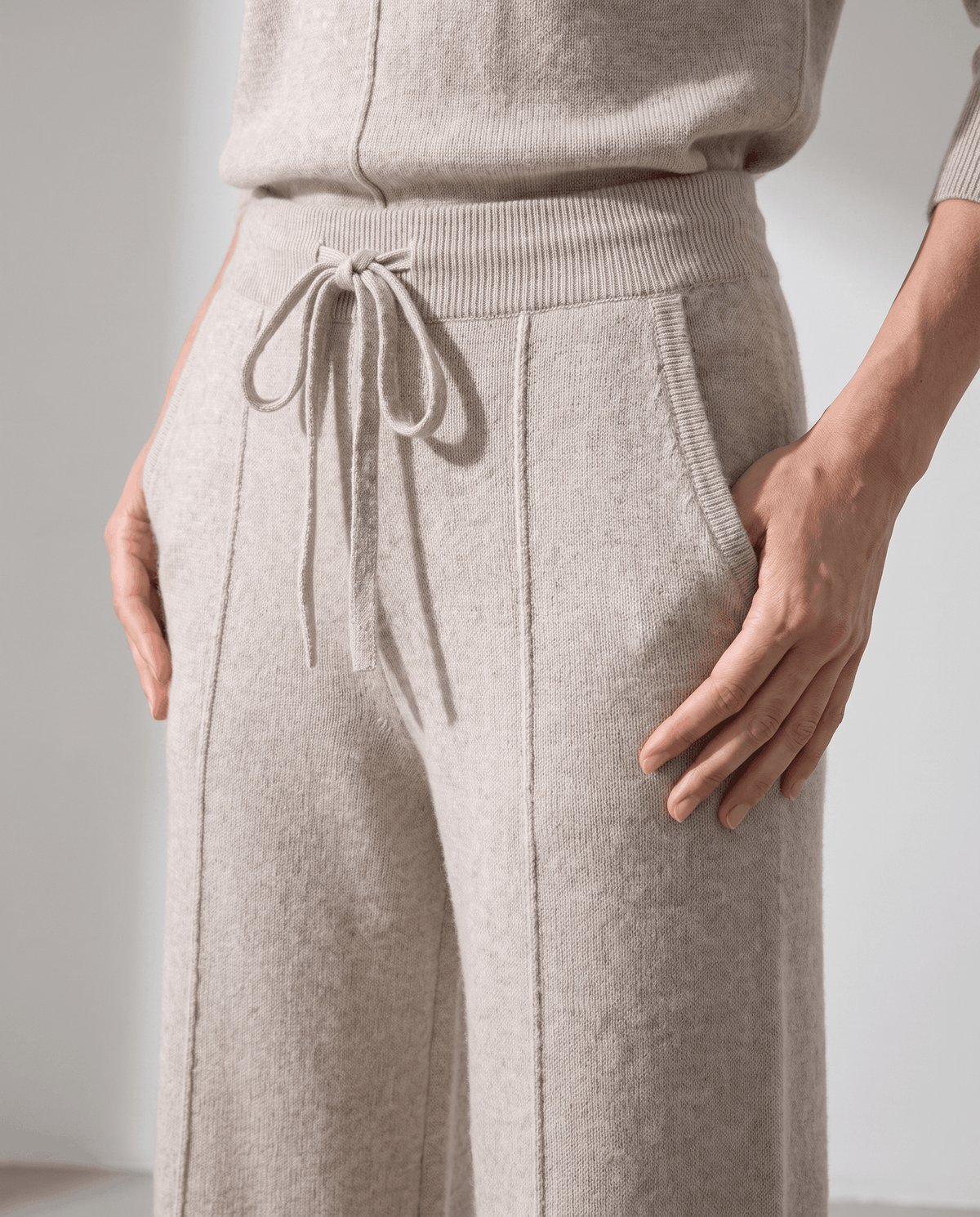 Close-up of beige ribbed waist, drawstring tie and side pocket