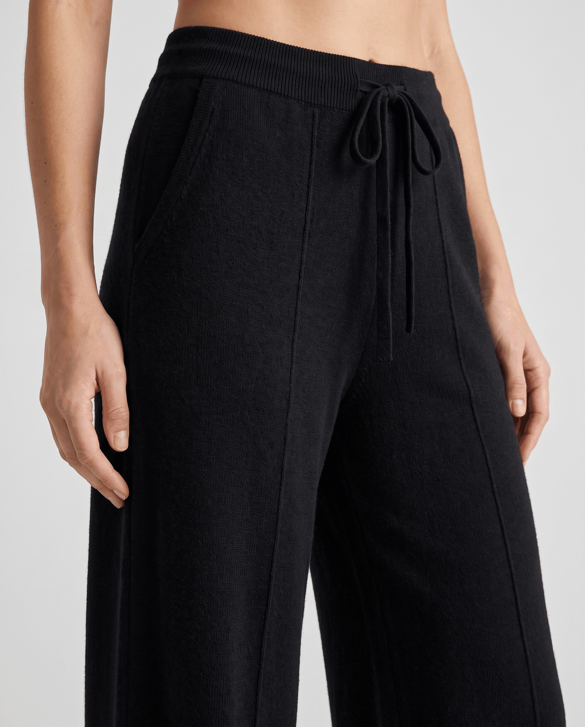 Front close-up of black drawstring waist and pintuck seam
