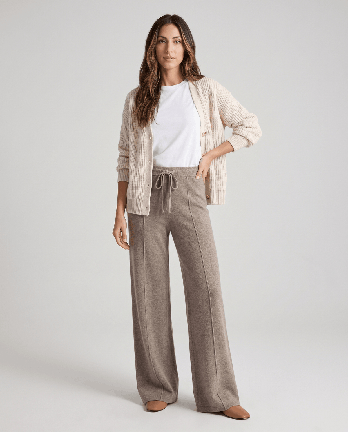 Model in cream cardigan and white tee wearing taupe wide-leg pants