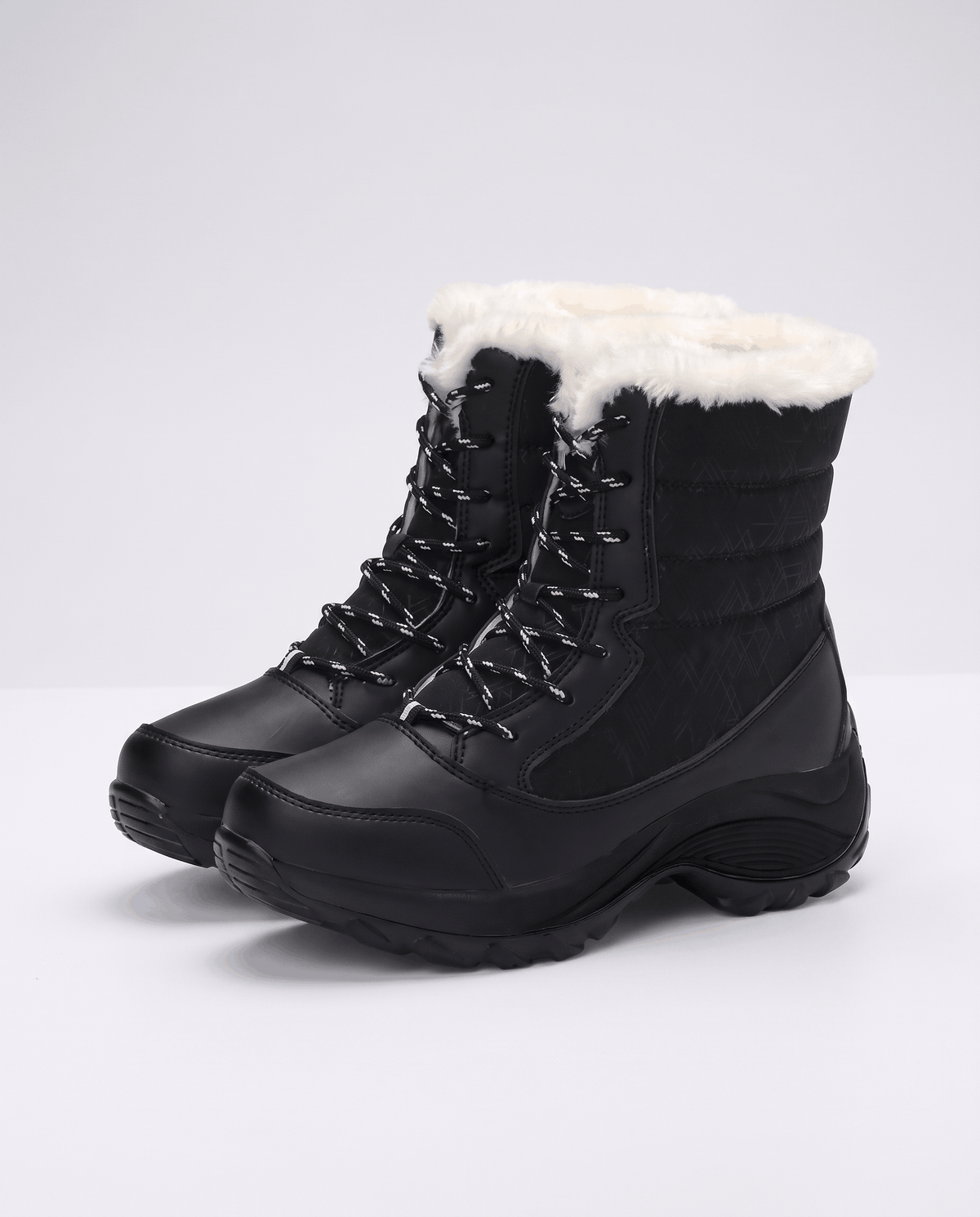 Pair of black quilted lace-up boots angled to show front lacing and platform sole