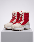 Red and beige mid-calf platform winter boots with lace-up front and plush collar on plinth