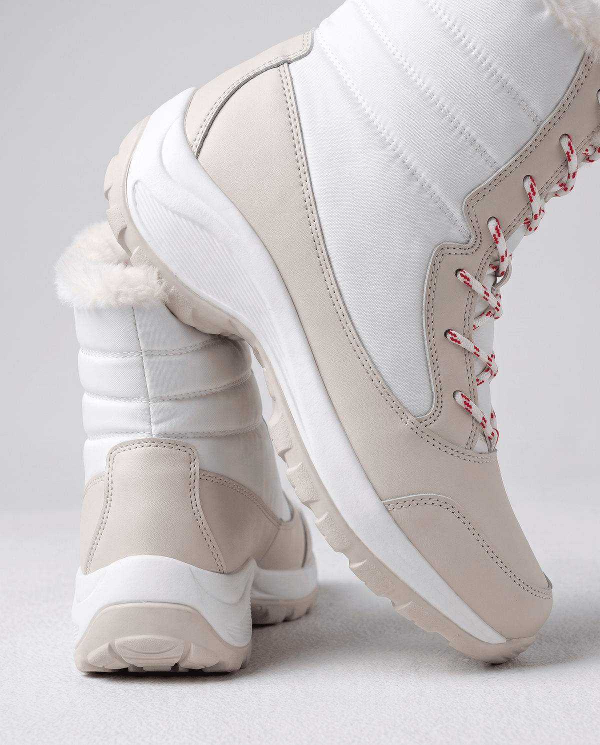 Detail of white quilted boot upper with cream panels and plush trimmed opening