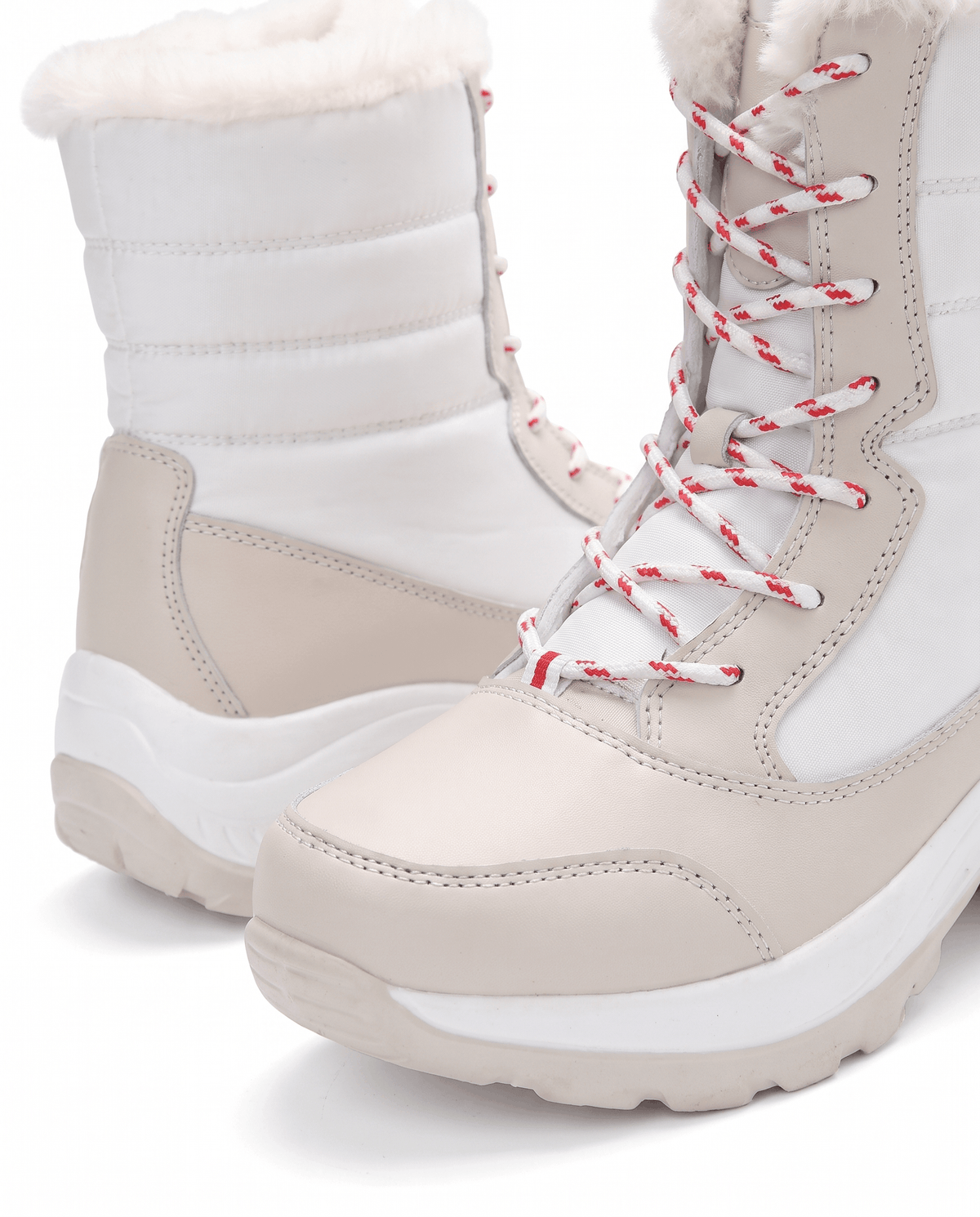 Close view of white lace-up boot with quilted upper, cream toe panel and soft collar trim