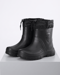 Black mid-calf rain boots with drawstring collars and treaded soles on a gray plinth