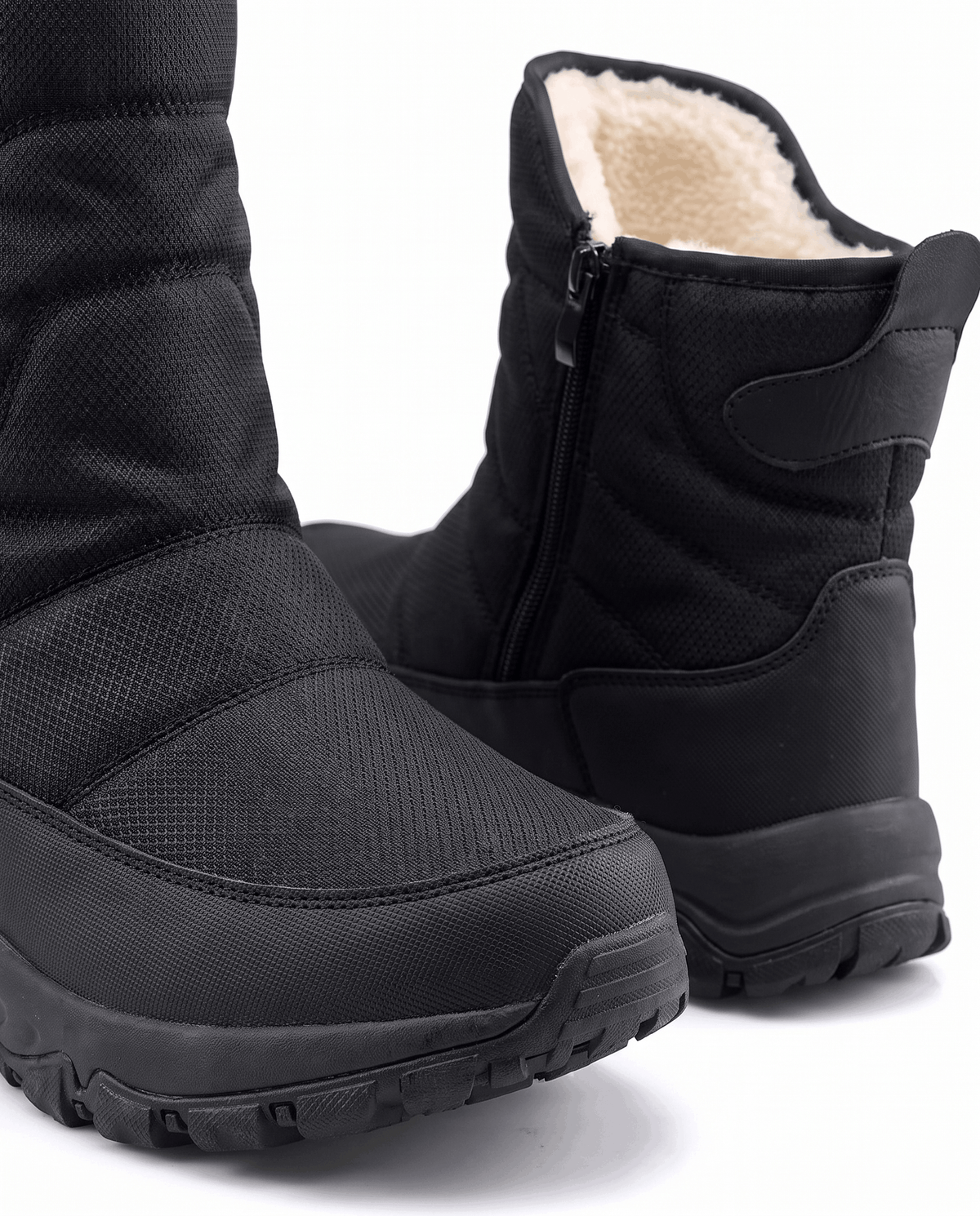 Close view of black quilted boot upper, fleece-lined opening and chunky lug sole
