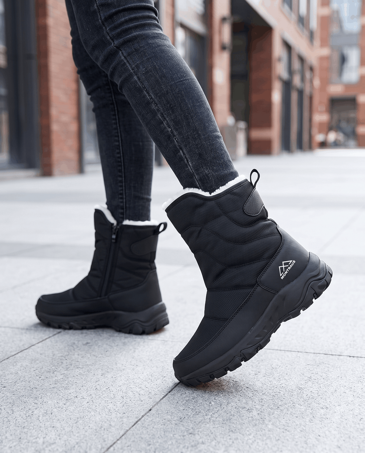 Black quilted boots with chunky soles worn with jeans on a city sidewalk