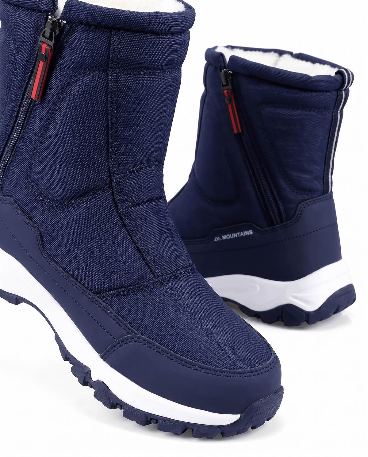 Close view of navy blue boot with quilted upper, zipper and fleece-trimmed opening