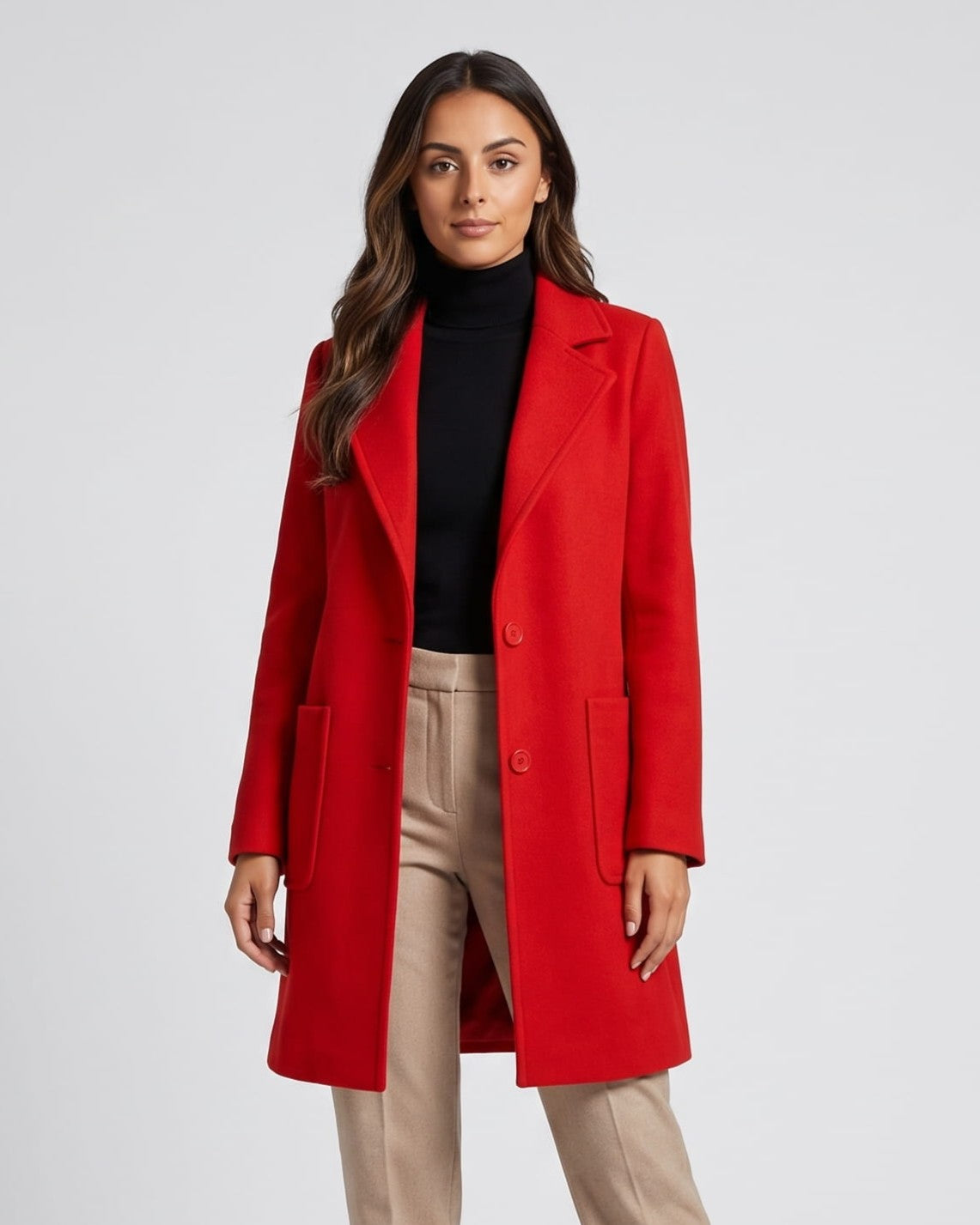 Cherry red coat worn over black turtleneck and beige trousers, front view