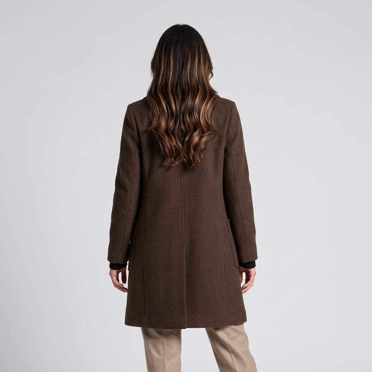 Back view of coffee brown coat worn with beige trousers