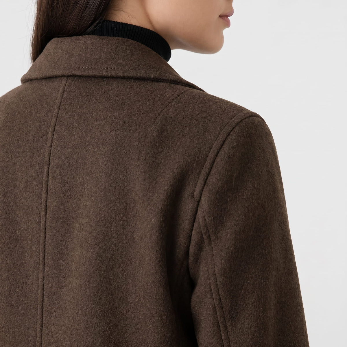 Close-up of coffee brown coat shoulder and collar showing the fabric texture