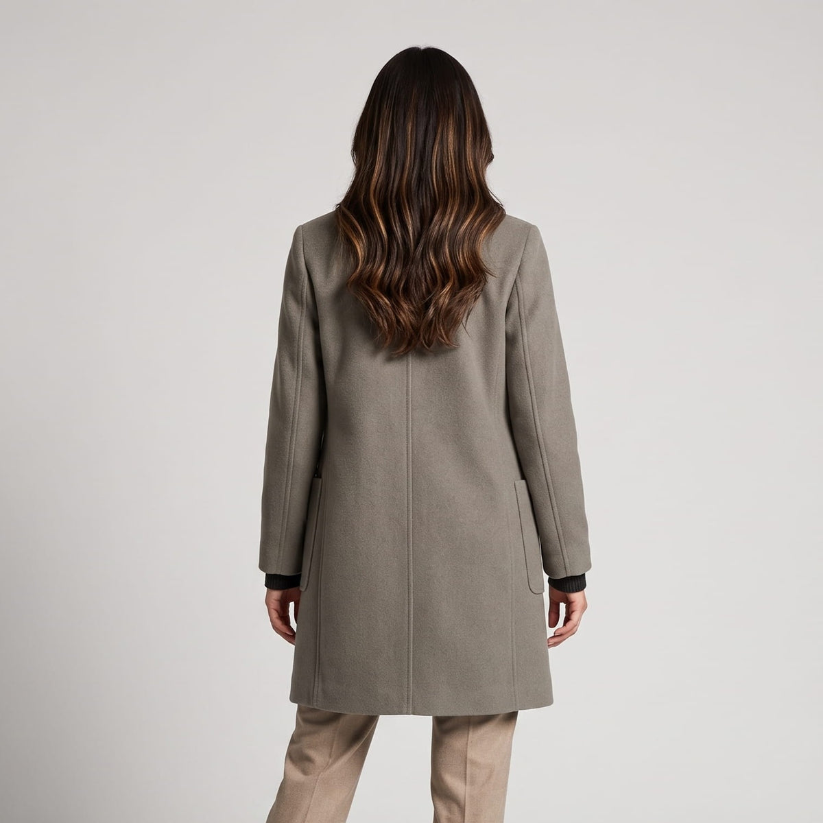 Back view of olive green coat with long sleeves and a straight hem