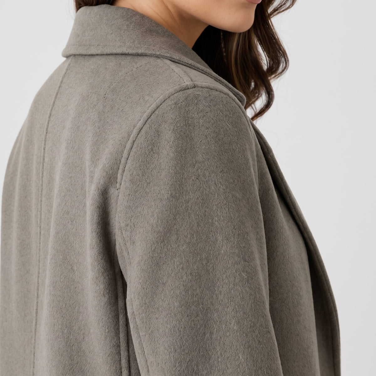 Detail of olive green coat collar and shoulder seen from behind