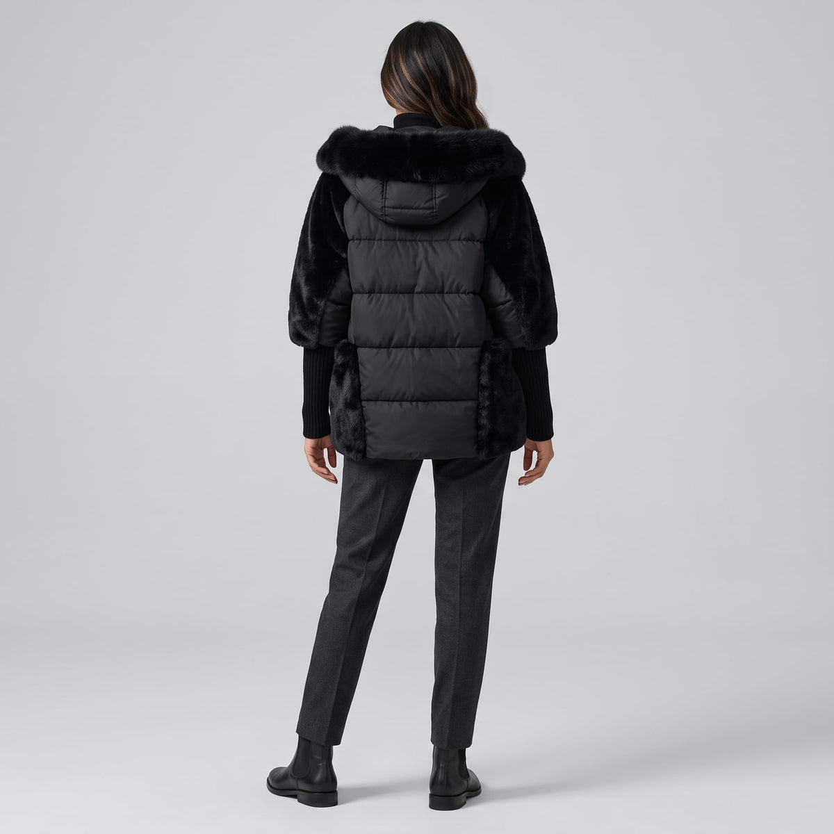Back view of black parka showing the plush hood and quilted body