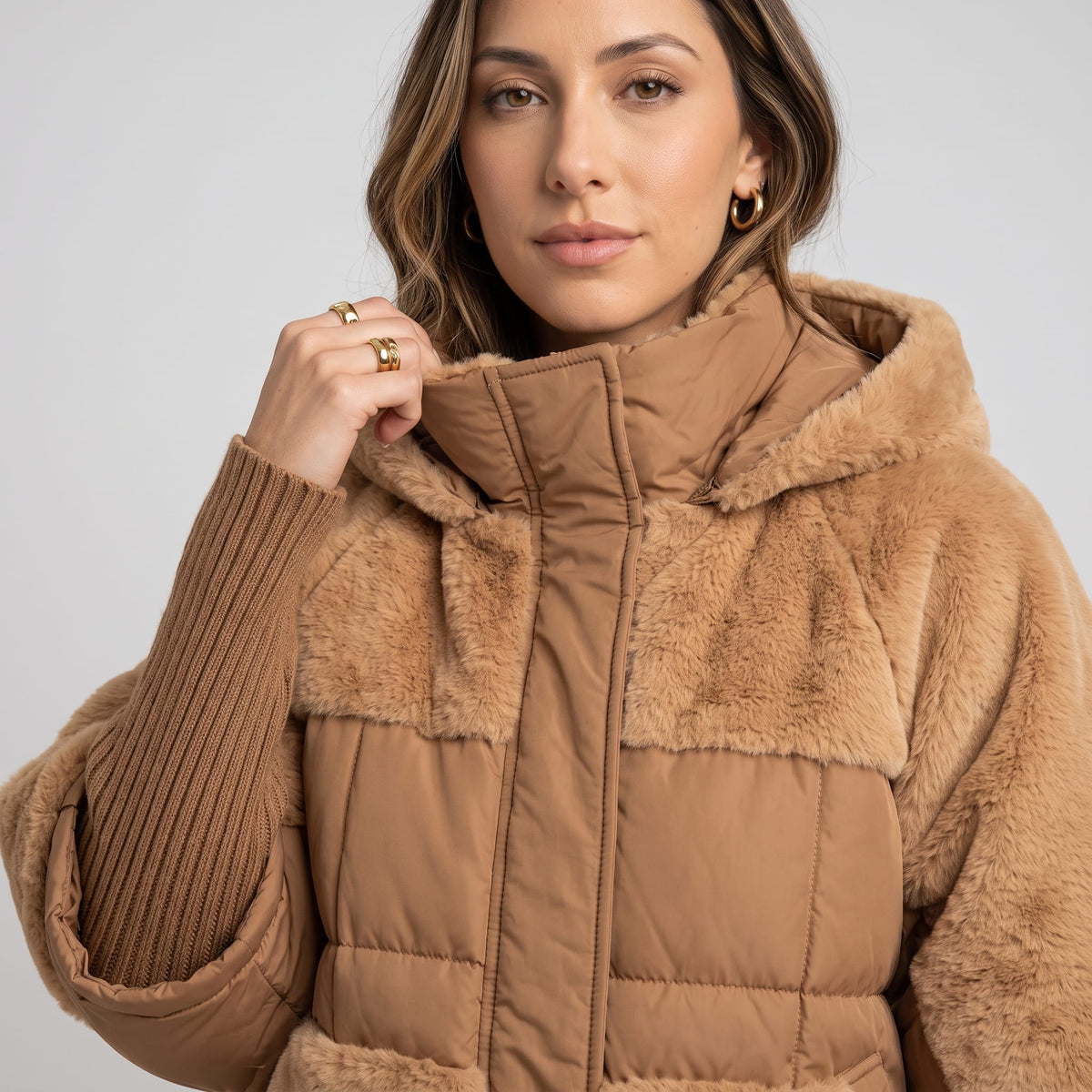 Close-up of brown parka high collar, plush yoke and ribbed cuffs