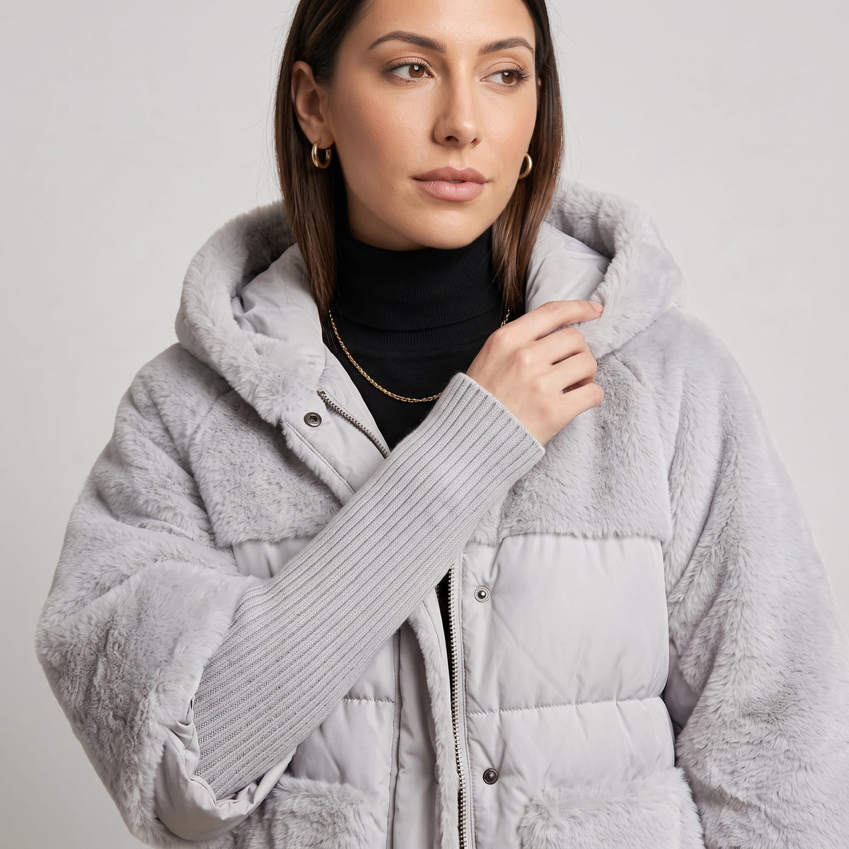 Close-up of gray parka snap placket with long ribbed knit sleeve