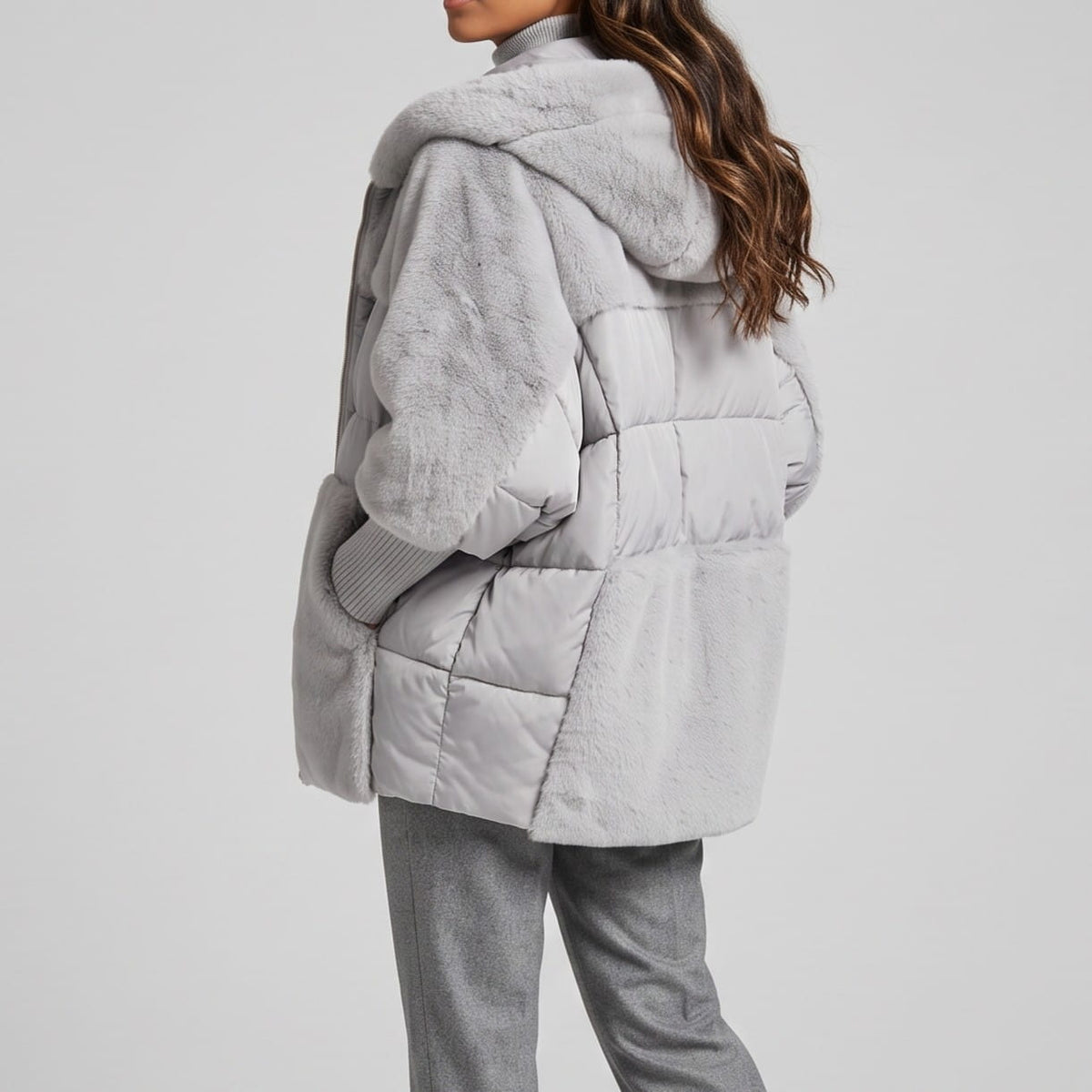 Side view of gray parka showing the plush sleeve panel and quilting