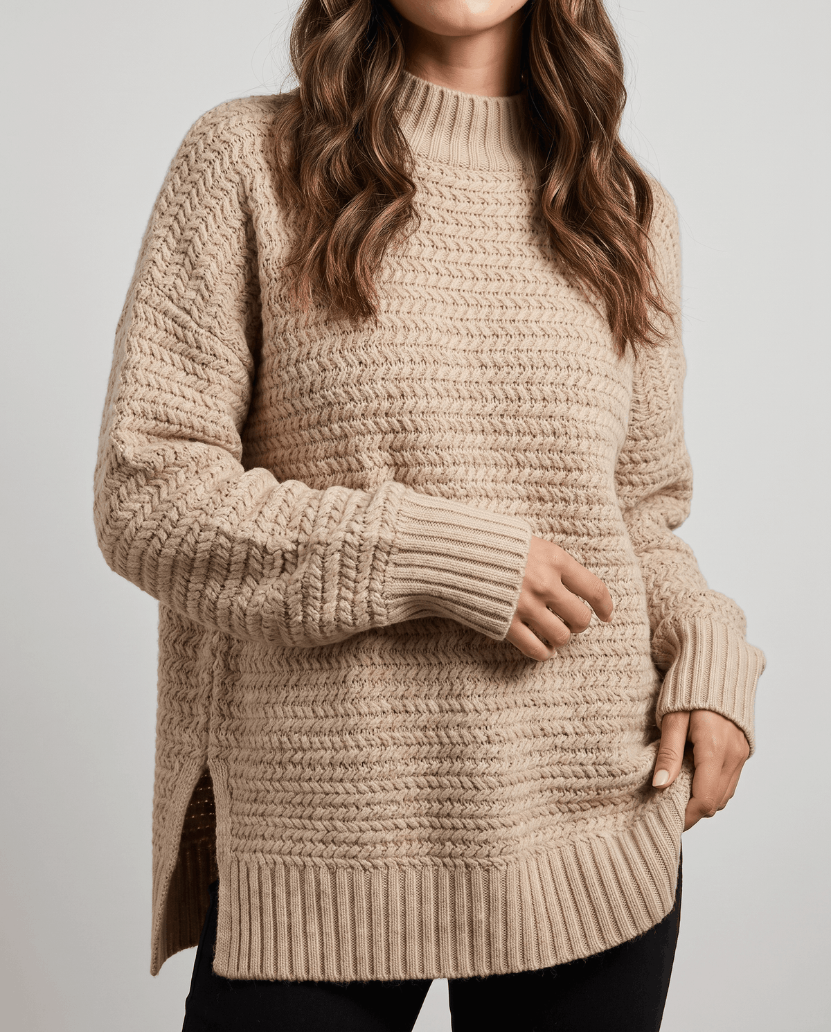 Cropped front view of beige textured pullover with long sleeves and side slits
