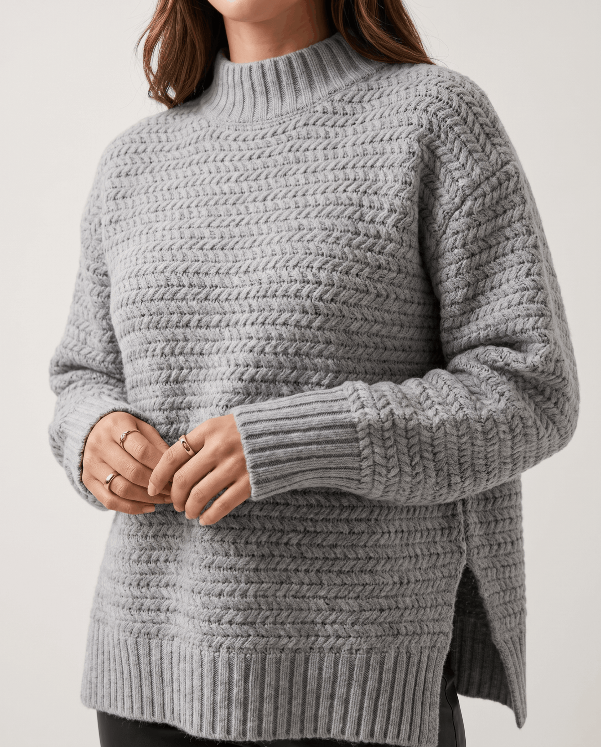 Cropped front view of gray textured pullover with side slits at the hem