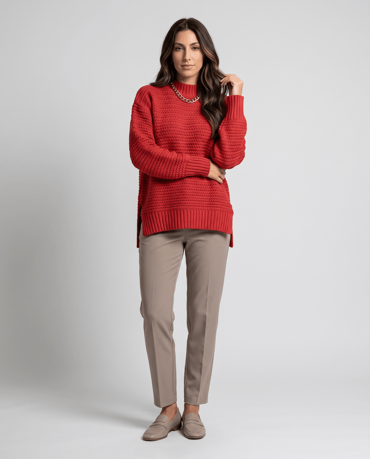 Full-length view of red mock neck sweater with khaki trousers and flats